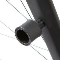 A black Restrap Light Mount attached to a bicycle fork