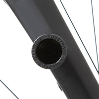 A black Restrap Light Mount attached to a bicycle fork