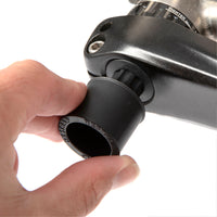 A black Restrap Light Mount being used as a crank extraction tool