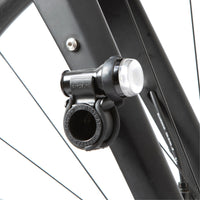 A black Restrap Light Mount attached to a bicycle fork, with a light on top.