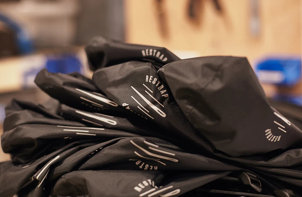 pile of partially made up restrap dry bags shown going through quality checks