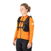 Woman wearing restrap race hydration vest, shown from a side-front view