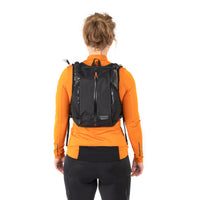 Woman wearing restrap race hydration vest, pictured from behind