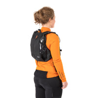 woman wearing restrap race hydration vest, shown from a rear quarter view