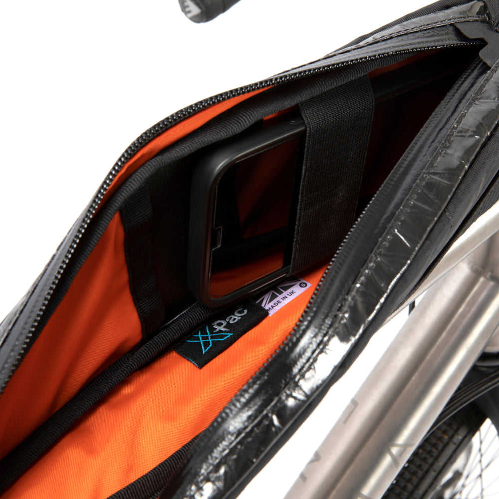 inside of restrap race top tube bag showing a strap designed to hold a phone