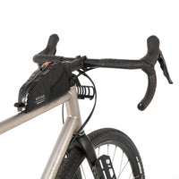 A black Race Top Tube Bag attached to the top tube of a bicycle, featuring a YKK aquaguard zip and reflective detailing.