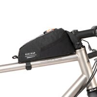 A black Race Top Tube Bag attached to the top tube of a bicycle, featuring a YKK aquaguard zip and reflective detailing.
