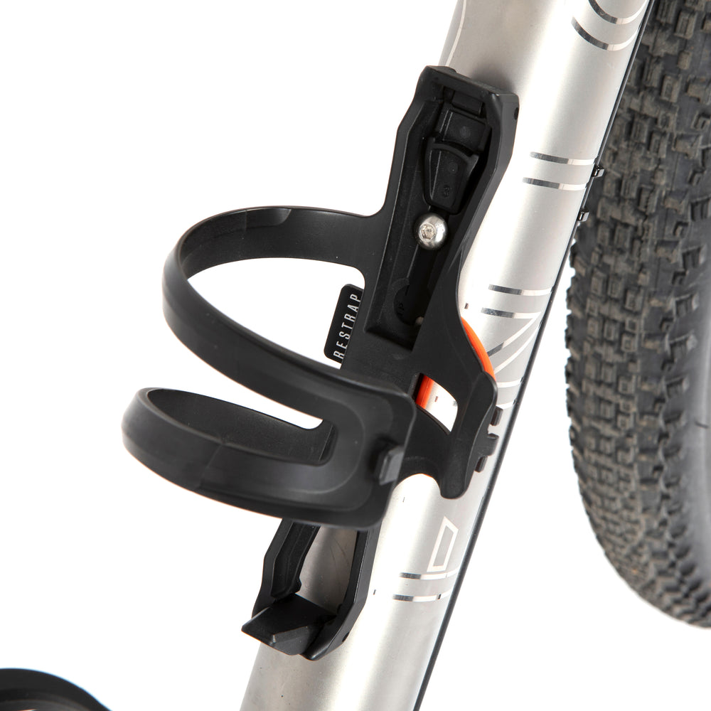 A black side release bottle cage mounted on a bicycle frame, with a side entry opening.