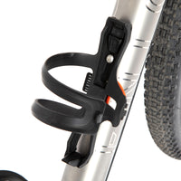 A black side release bottle cage mounted on a bicycle frame, with a side entry opening.
