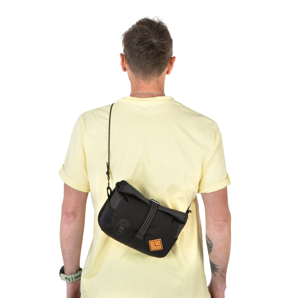 Person wearing the Rolltop Canister Bag as a cross body bag