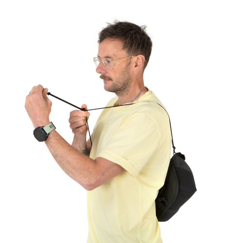 man demonstrating how to fit the rolltop canister bag fits on body