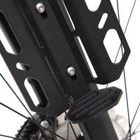 close up of A black laser cut aluminium cargo cage mounted to the fork of a bicycle