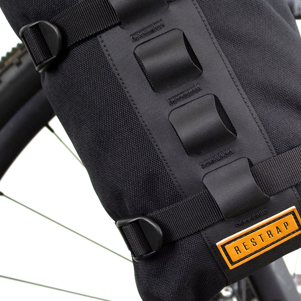 closeup of a black Restrap Fork Bag attached to a bicycle fork cage, designed to be waterproof and carry 5 liters.