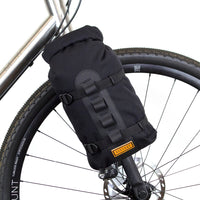 fork bag attached to restrap carry cages on a bicycle fork