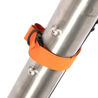 Orange hike a bike harness straps attached to the frame of a bicycle, designed for carrying the bike on one's back.