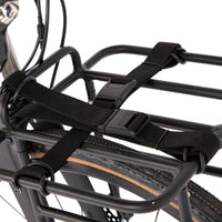 Restrap luggage straps with rubber o-rings and magnetic buckles on a white background mounted onto a front rack on a bicycle