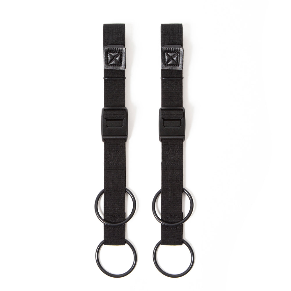 A pair of black Restrap luggage straps with rubber o-rings and magnetic buckles on a white background.