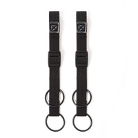 A pair of black Restrap luggage straps with rubber o-rings and magnetic buckles on a white background.