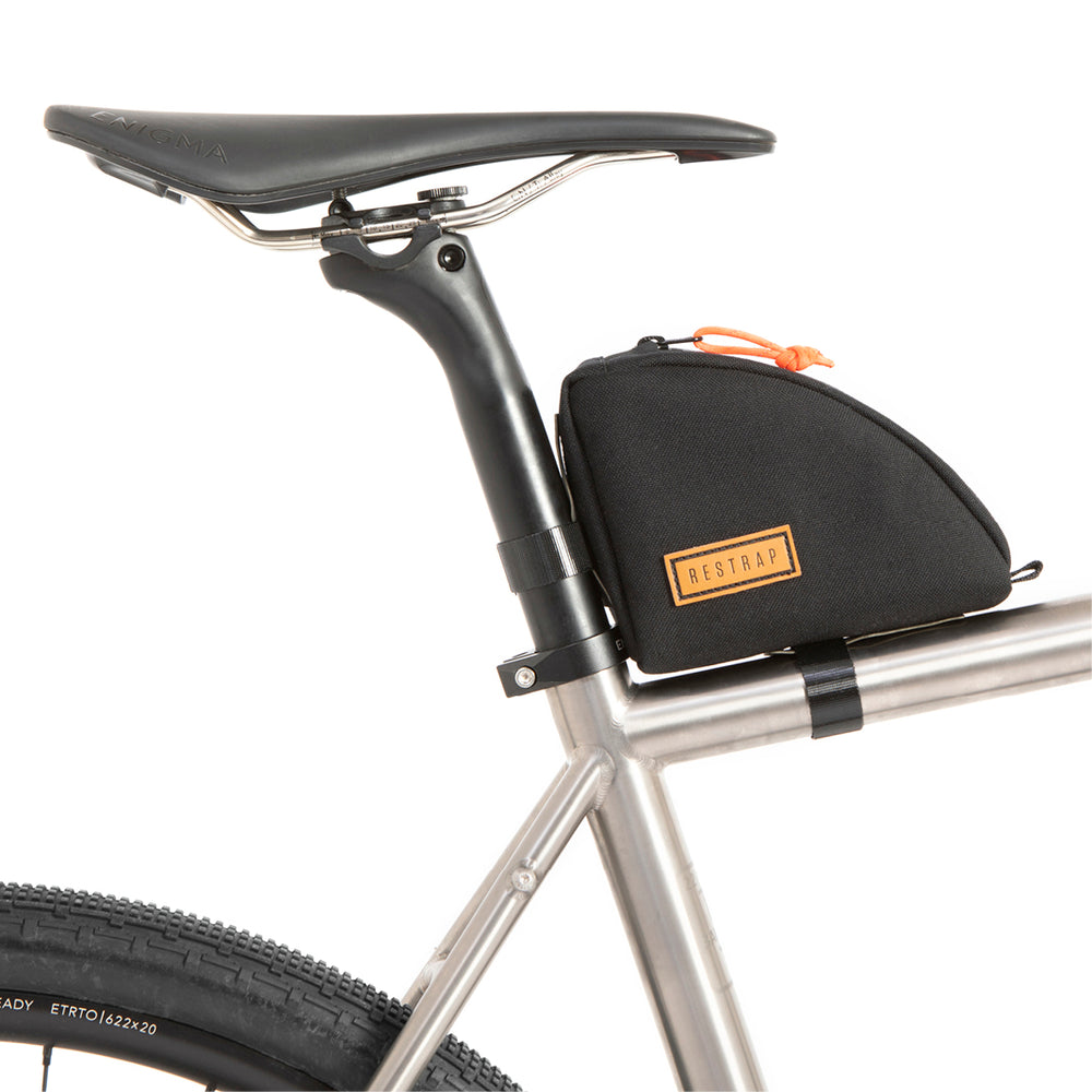 A black Rear Top Tube Bag attached to the top tube of a bicycle just below the seat, featuring a simple zip closure and a small label with the brand name.