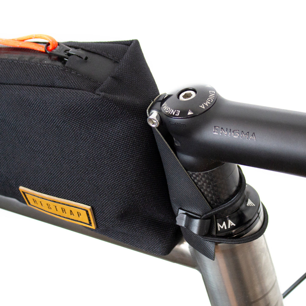 closeup of how restrap top tube bag fits onto the headtube of a bicycle