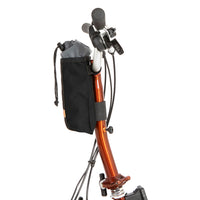 A black City Stem Bag with a capacity of 1 litre, attached to the handlebars of a folding bicycle.