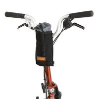 A black City Stem Bag with a capacity of 1 litre, attached to the handlebars of a folding bicycle.