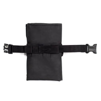 A black Restrap tool roll with a visible brand label, designed to be attached to a bicycle saddle or kept in a jersey pocket.