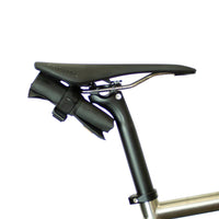 A black Restrap tool roll with a visible brand label, designed to be attached to a bicycle saddle or kept in a jersey pocket.