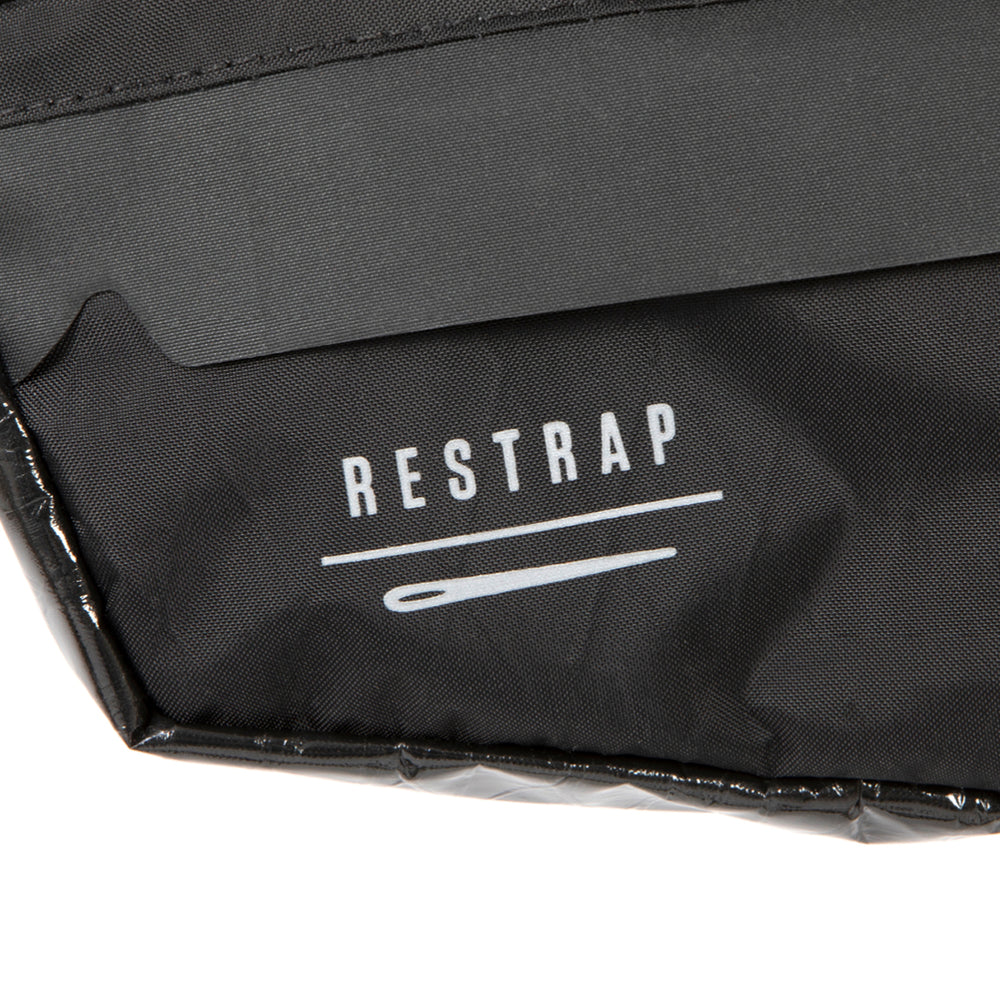 closeup of the label on A small black race frame bag attached to the frame of a bicycle, designed for bikepacking.
