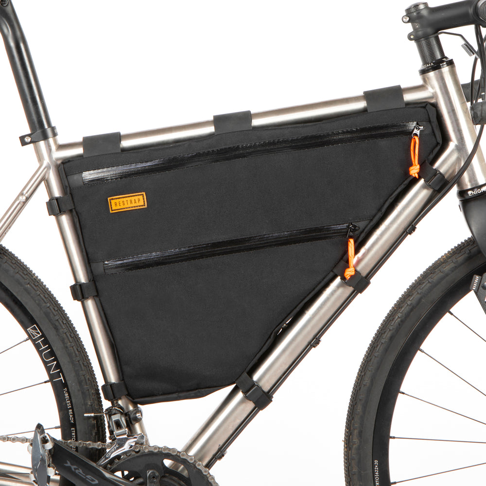 A custom frame bag attached to a bicycle frame, featuring the double zip option in black