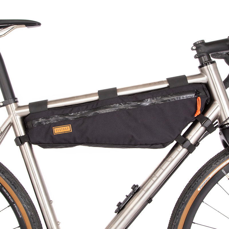 A large black Restrap frame bag attached to a bicycle frame, designed for carrying additional items while biking.