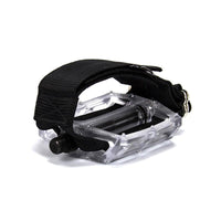 A black Restrap horizontal pedal strap fitted onto a cycling pedal, with visible nylon webbing and metal buckle.