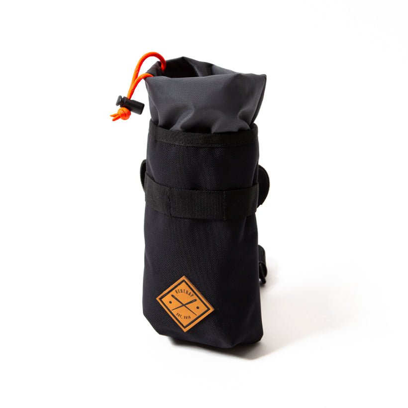 A black Restrap stem bag, designed for carrying a water bottle or other items, with an orange drawstring and the Restrap logo in yellow.