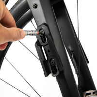 Person tightening a screw on a switch multi mount
