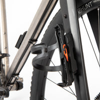 Bicycle water bottle holder and switch multi mount attached to a bike fork