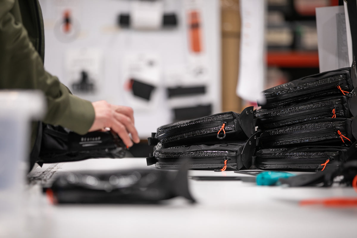 stack of restrap top tube bags being quality checked