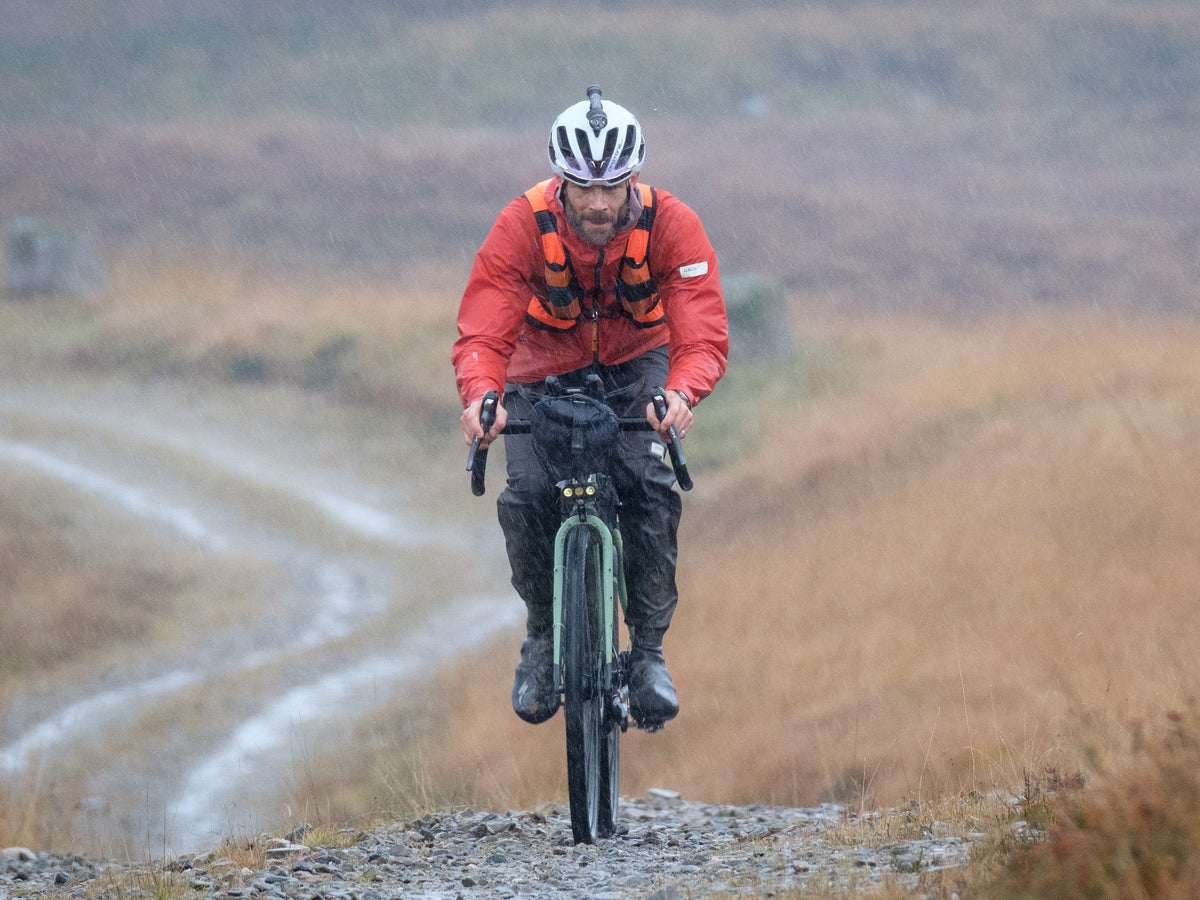 rider on a gravel bike riding in heavy rain