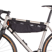 A large black Restrap frame bag attached to a bicycle frame, designed for carrying additional items while biking shown from the non drive side